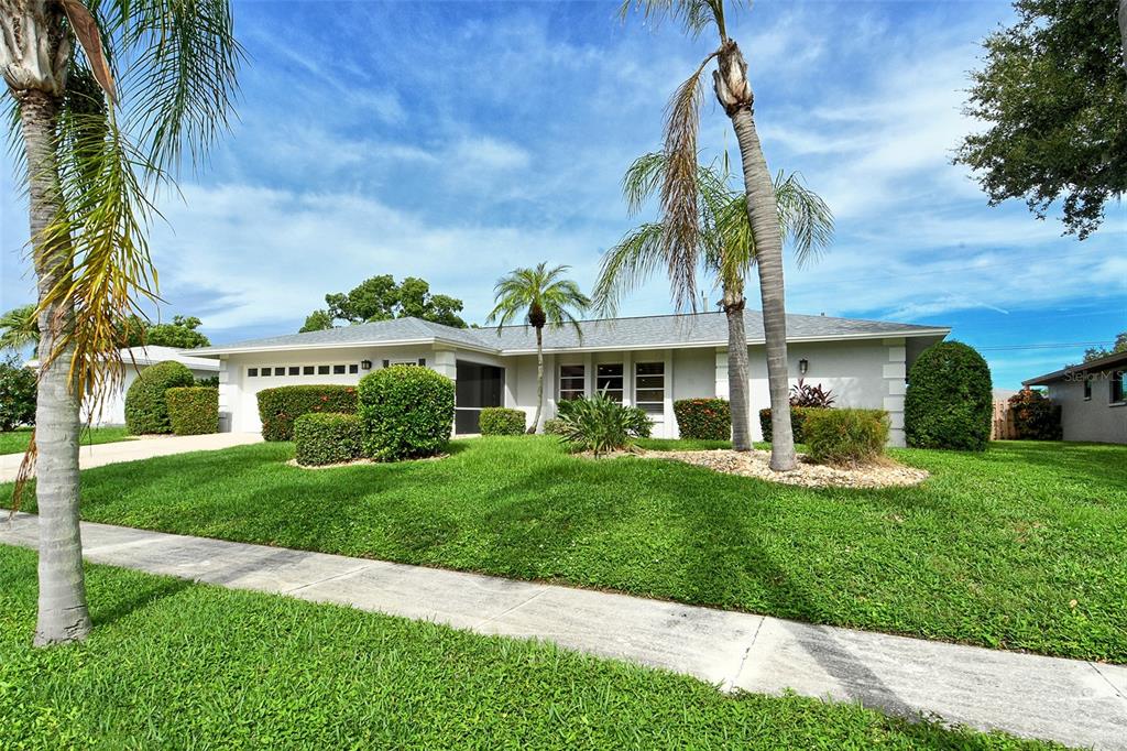 6722 Roxbury Drive Sarasota, FL 34231 - Photo 3 of 87 a front view of a house with a garden and plants