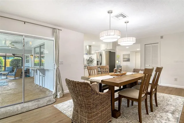 a view of a backyard with plants and a large tree