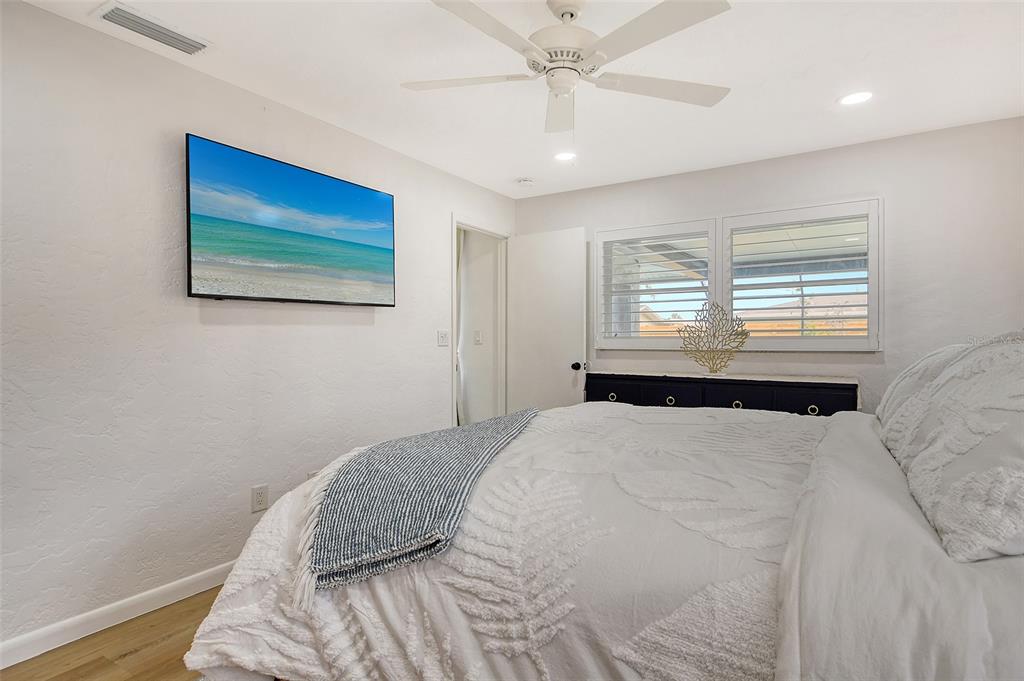 6722 Roxbury Drive Sarasota, FL 34231 - Photo 36 of 87 a bedroom with a bed and a painting on the wall