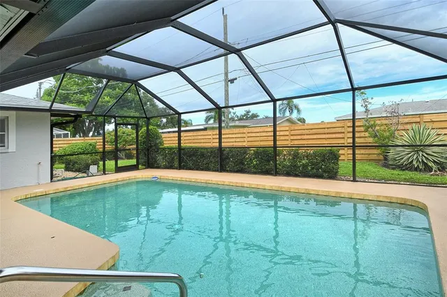 a front view of a house with a yard and potted plants