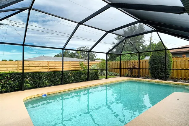a view of outdoor space with swimming pool and seating