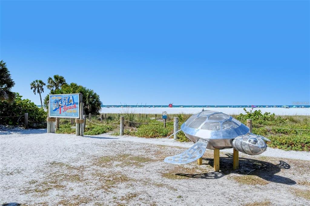 6722 Roxbury Drive Sarasota, FL 34231 - Photo 69 of 87 a table and chairs under an umbrella