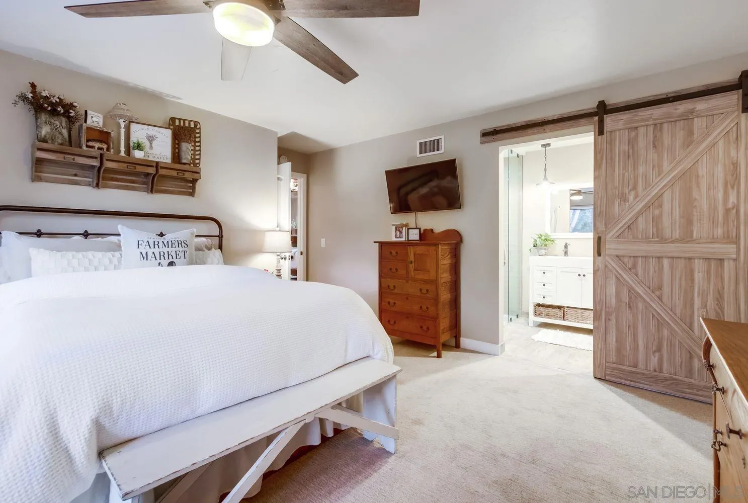 17048 Handlebar Road Ramona, CA 92065 - Photo 16 of 75 a bedroom with a bed a flat screen tv and a chandelier