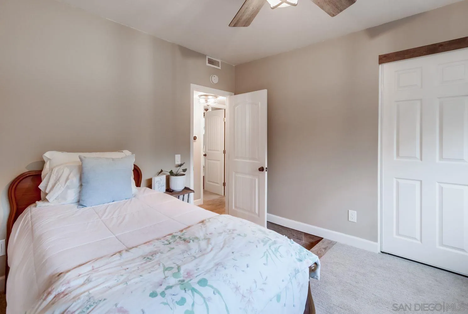 17048 Handlebar Road Ramona, CA 92065 - Photo 21 of 75 a bedroom with a large bed and a chandelier