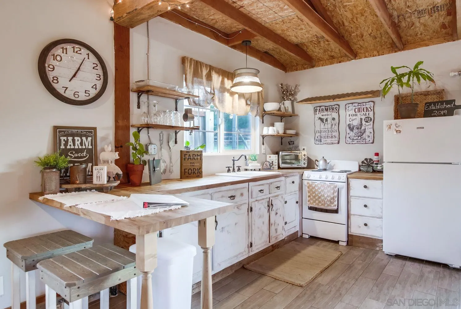 17048 Handlebar Road Ramona, CA 92065 - Photo 55 of 75 a kitchen with cabinets and wooden floor