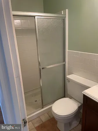 a bathroom with a toilet and a shower