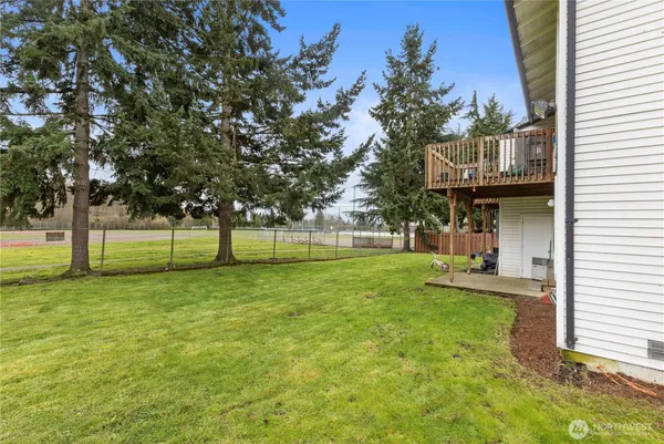 a view of a house with backyard and porch