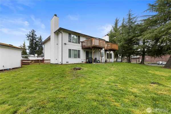 a view of a house with a yard and sitting area