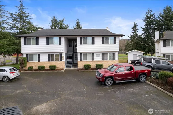 a front view of a house with parking space
