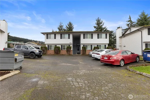 a couple of cars parked in front of a house