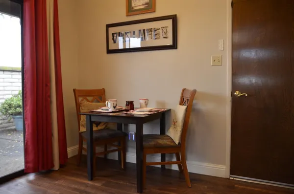 a view of a dining room with furniture and wooden floor