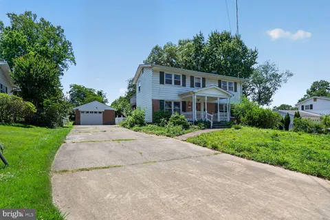 a house that has a tree in front of the house