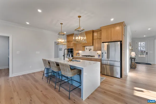 a dining room filled chandelier and wooden floor