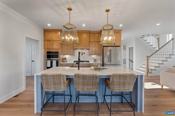 a kitchen with stainless steel appliances kitchen island a large island in the center