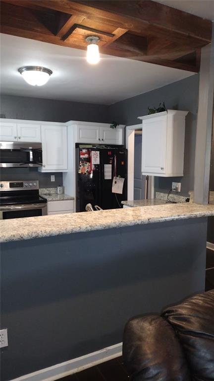 136 Hill Street Commerce, GA 30529 - Photo 16 of 27 a kitchen with kitchen island a stove and a sink