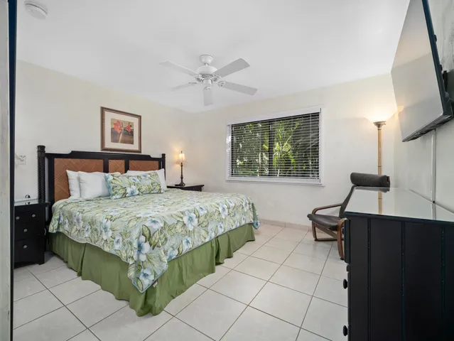 a large bed sitting in a bedroom next to a window