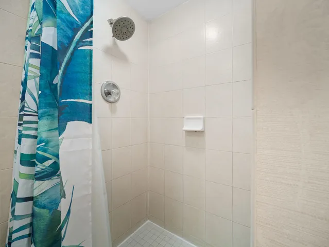 a bedroom with bed and a chandelier