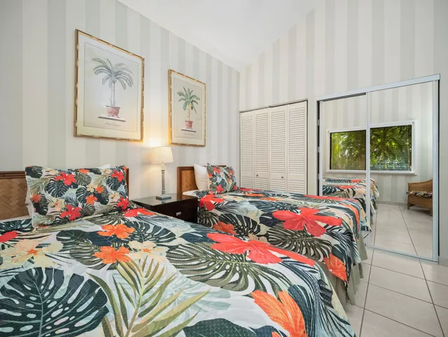 a bathroom with a double vanity sink mirror and toilet