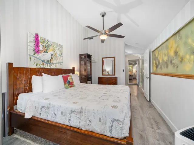 a large bed sitting in a bedroom next to a window