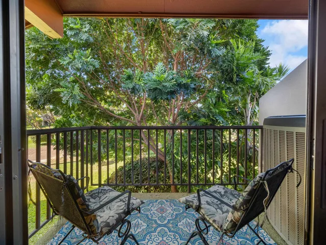 a view of a balcony with wooden fence and floor
