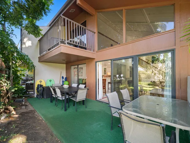 a view of a house with backyard porch and sitting area