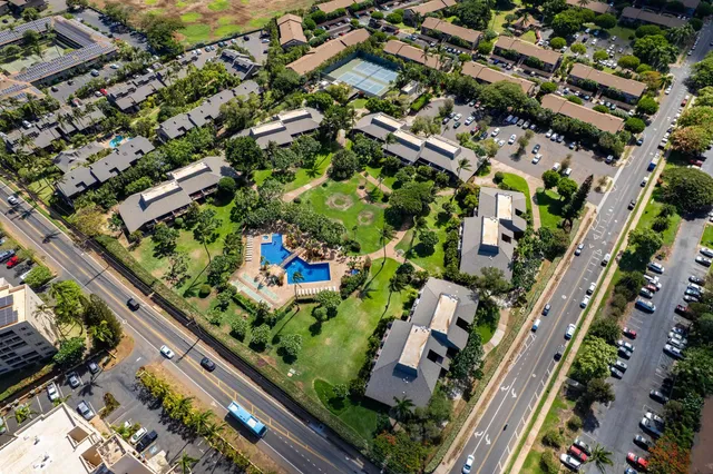 a room with lots of wooden furniture and windows