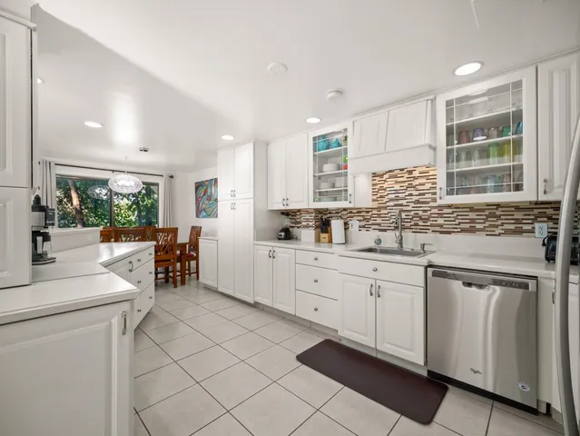 a living room with lots of furniture and kitchen view