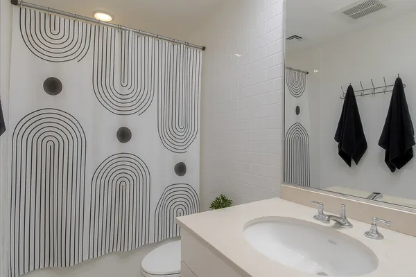 a view of a room with wooden floor and bathroom