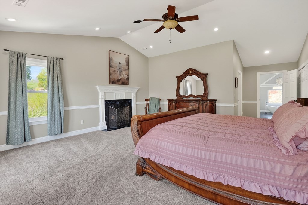 4671 Bunker Hill Road Cookeville, TN 38506 - Photo 27 of 87 a bedroom with a bed and a fireplace