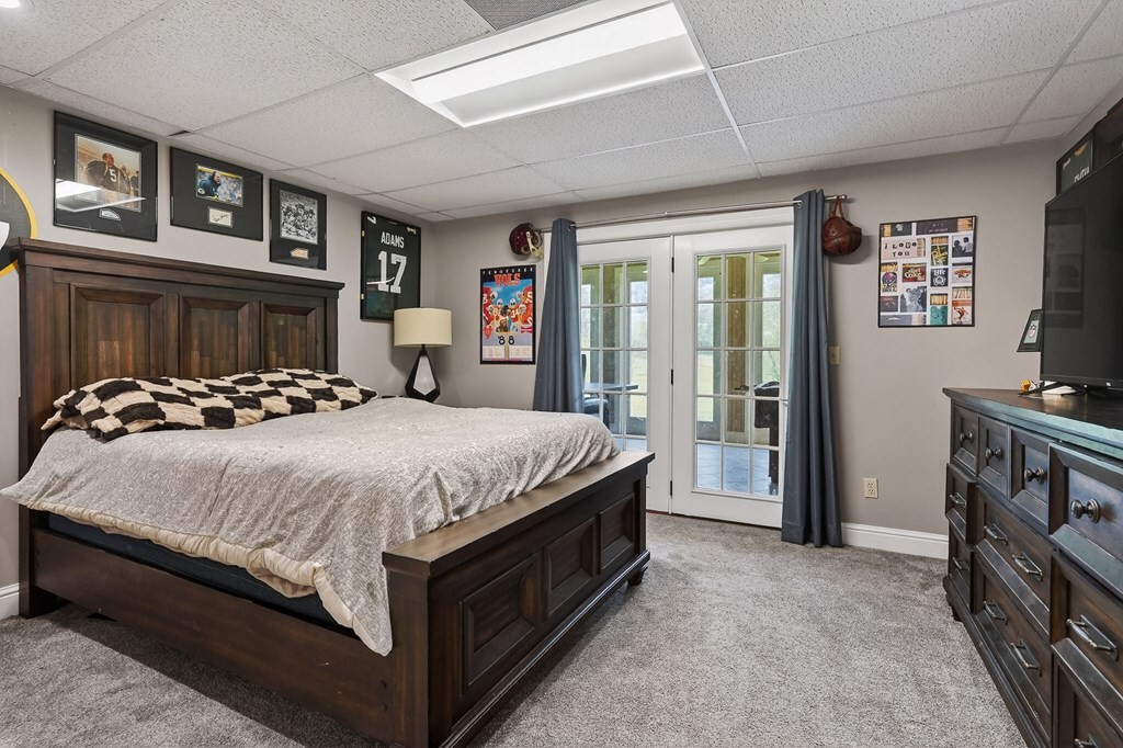 4671 Bunker Hill Road Cookeville, TN 38506 - Photo 55 of 87 a spacious bedroom with a bed and a tv on dresser