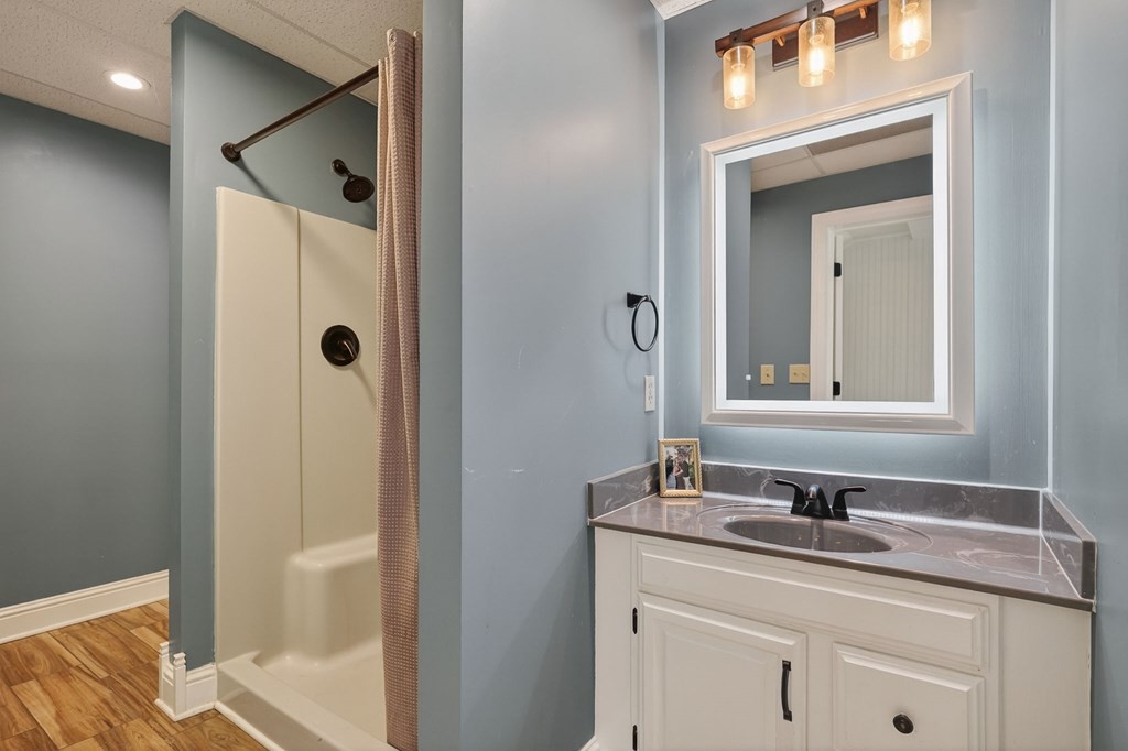 4671 Bunker Hill Road Cookeville, TN 38506 - Photo 56 of 87 a bathroom with a granite countertop sink and a mirror