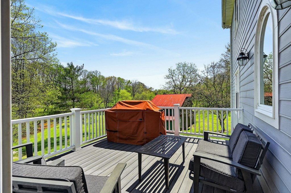 4671 Bunker Hill Road Cookeville, TN 38506 - Photo 62 of 87 a balcony with wooden floor table and chairs