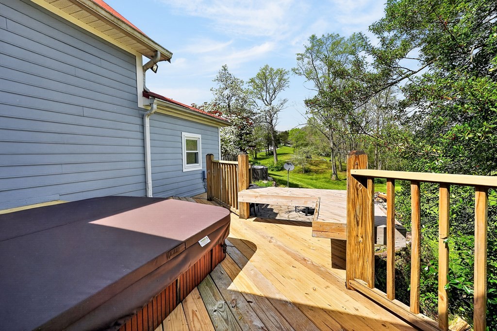 4671 Bunker Hill Road Cookeville, TN 38506 - Photo 63 of 87 a balcony with wooden floor table and chairs