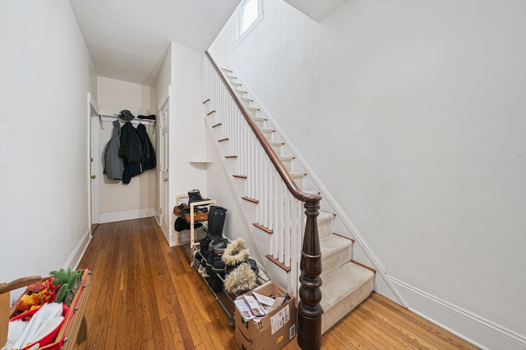 167 Middle Street Braintree, MA 02184 - Photo 12 of 30 a view of stairs and a room with wooden floor