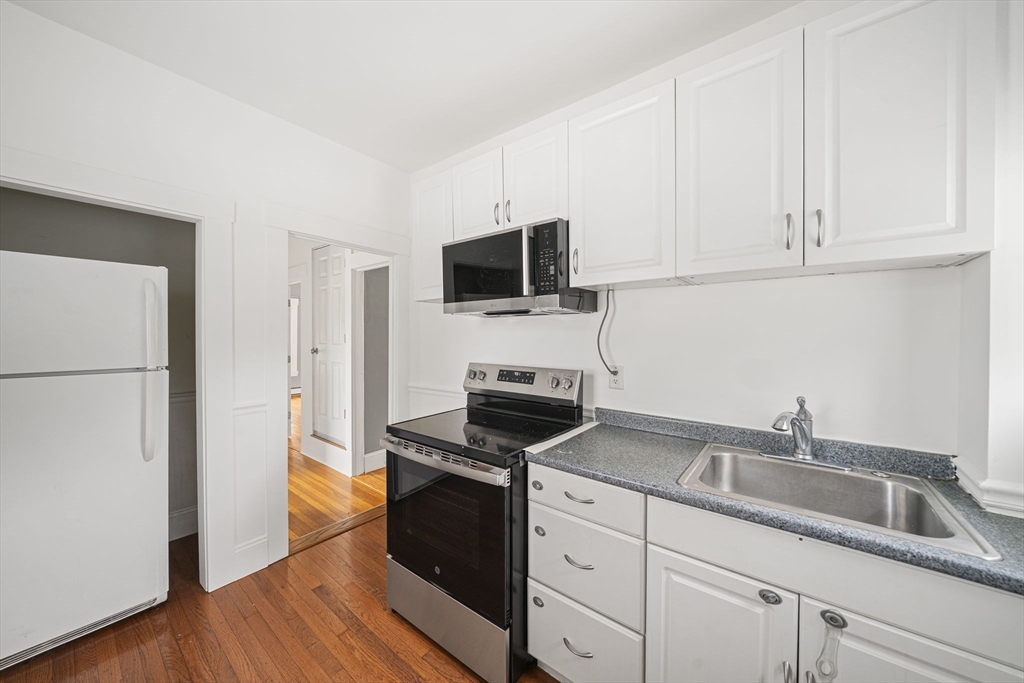 167 Middle Street Braintree, MA 02184 - Photo 14 of 30 a kitchen with appliances a sink and cabinets