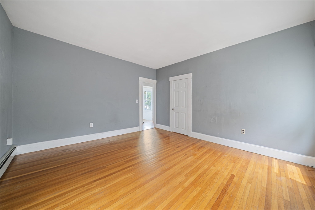 167 Middle Street Braintree, MA 02184 - Photo 16 of 30 a view of an empty room with wooden floor and a window