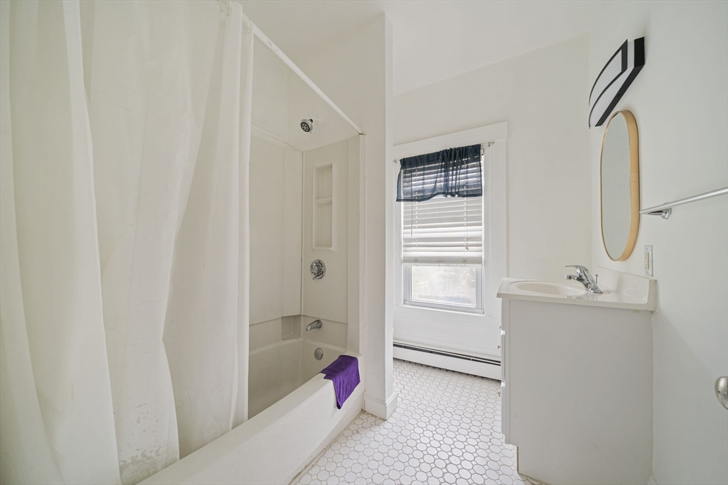 167 Middle Street Braintree, MA 02184 - Photo 19 of 30 a bathroom with a tub sink and mirror
