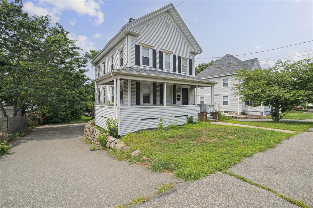 167 Middle Street Braintree, MA 02184 - Photo 2 of 30 a front view of a house with a garden and trees