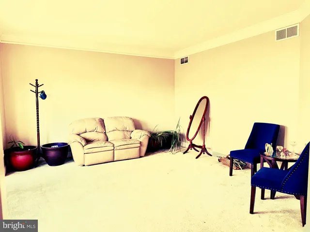 a living room with furniture and a floor to ceiling windows