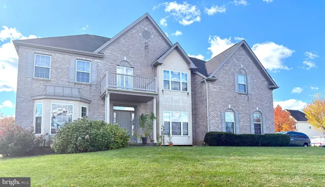 a view of a brick house with a yard