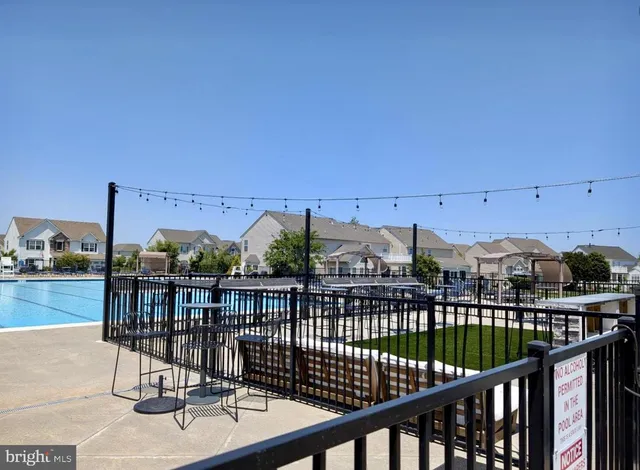 a view of swimming pool is middle in the middle of a house