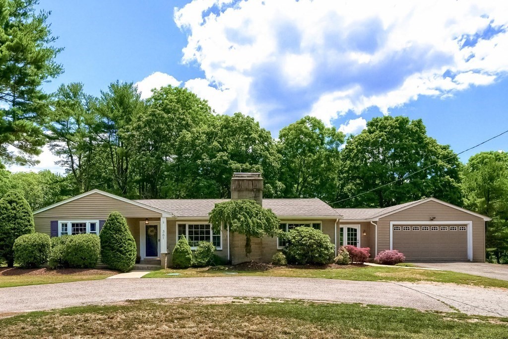 361 South Main Street Bellingham, MA 02019 - Photo 1 of 42 a front view of a house with a garden and trees