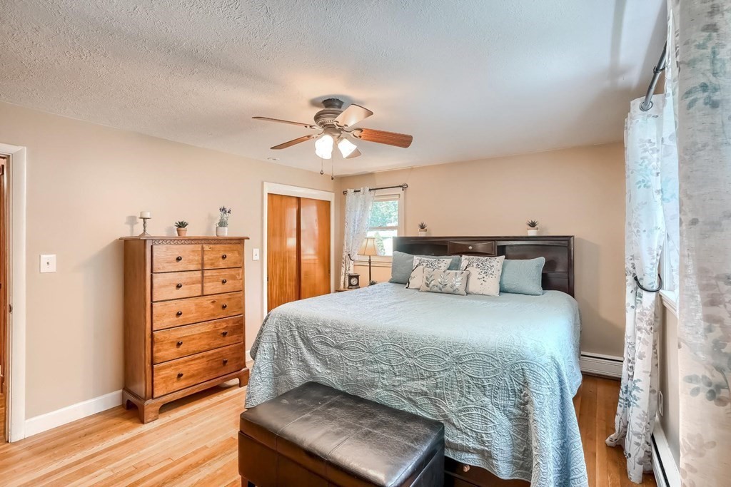 361 South Main Street Bellingham, MA 02019 - Photo 18 of 42 a bedroom with a bed and a chandelier