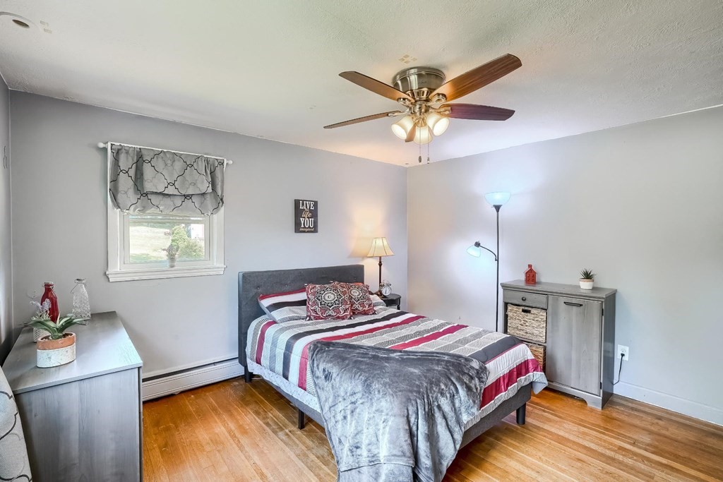 361 South Main Street Bellingham, MA 02019 - Photo 19 of 42 a bedroom with a bed and a chandelier
