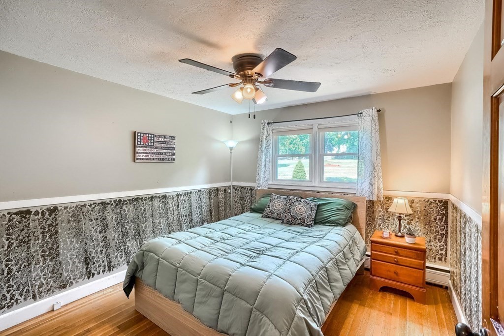 361 South Main Street Bellingham, MA 02019 - Photo 21 of 42 a bedroom with a bed and a chandelier