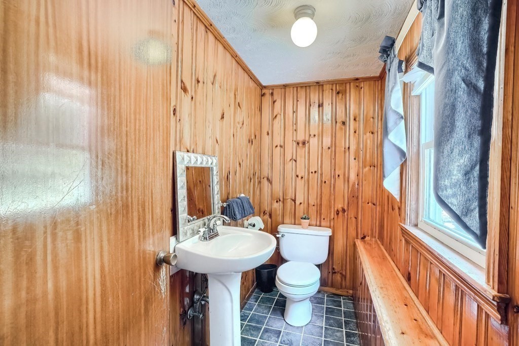 361 South Main Street Bellingham, MA 02019 - Photo 24 of 42 a bathroom with a sink a toilet and shower curtain