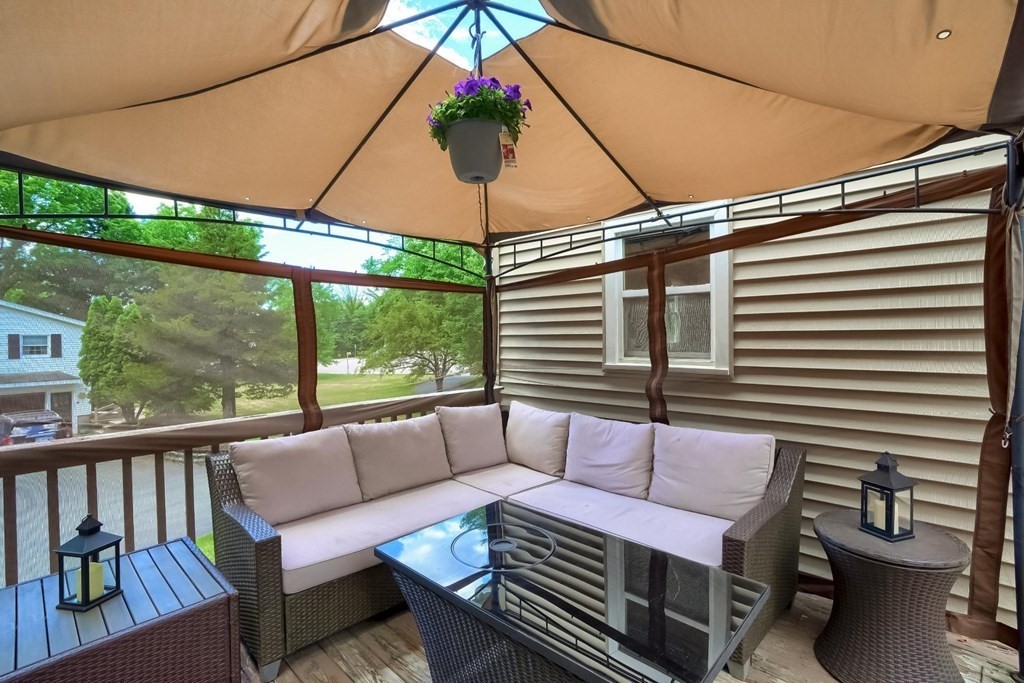 361 South Main Street Bellingham, MA 02019 - Photo 40 of 42 a view of a patio with a table and chairs under an umbrella