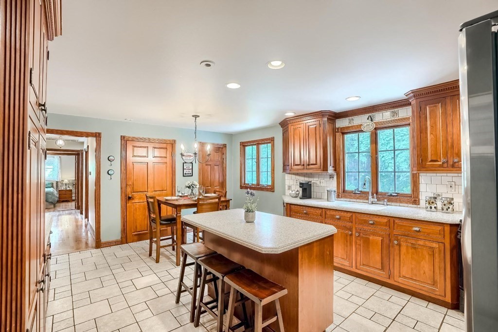 361 South Main Street Bellingham, MA 02019 - Photo 7 of 42 a kitchen with a sink and wooden cabinets