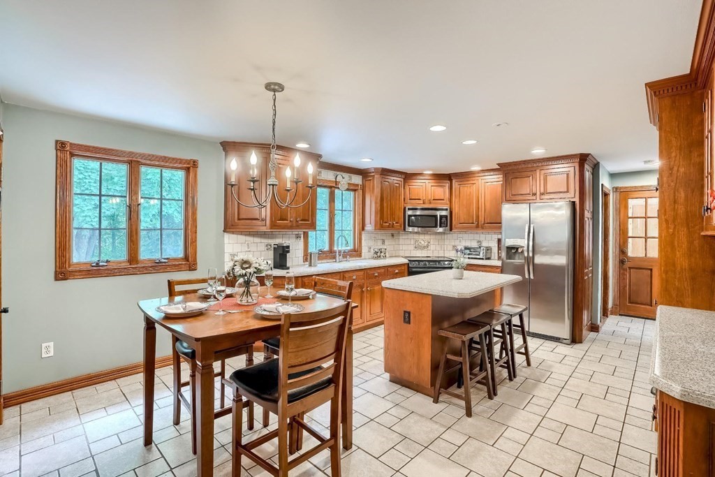 361 South Main Street Bellingham, MA 02019 - Photo 8 of 42 a kitchen with a dining table chairs stainless steel appliances and cabinets