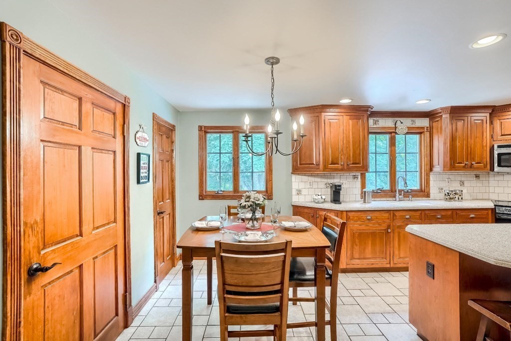 361 South Main Street Bellingham, MA 02019 - Photo 9 of 42 a kitchen with a sink and chairs
